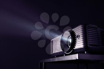 Modern video projector on dark background�