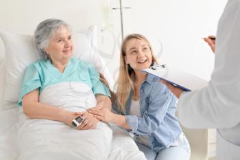 Young woman visiting her grandmother in hospital 