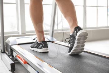 Senior man training on treadmill at home�