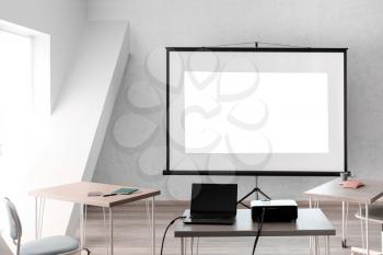 Video projector with laptop on table in conference hall�