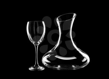 Empty decanter and glass on dark background�