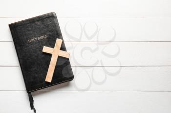 Holy Bible and cross on white wooden background�