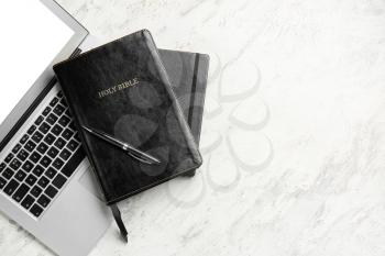 Holy Bible and laptop on light background�