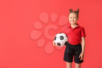 Little girl with soccer ball on color background�