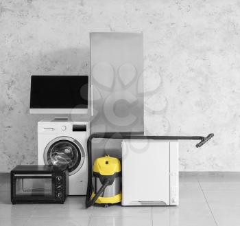 Different household appliances near light wall�