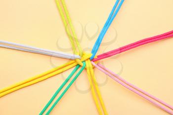 Tied ropes on color background. Unity concept�
