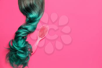 Unusual wig and brush on color background�