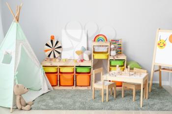 Interior of modern children's room with play tent and toys�