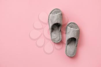 Pair of soft slippers on color background�