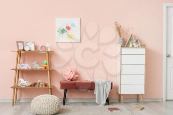 Interior of modern children's room with comfortable bench and toys�