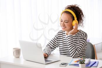 Young woman using laptop for online learning at home�