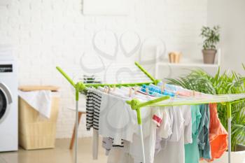 Clean clothes hanging on dryer in laundry room�