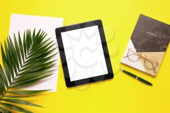 Composition with modern tablet computer on color background�
