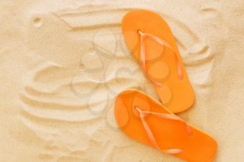 Stylish flip-flops on beach sand�