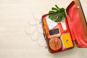 Packed suitcase on light background. Travel concept�