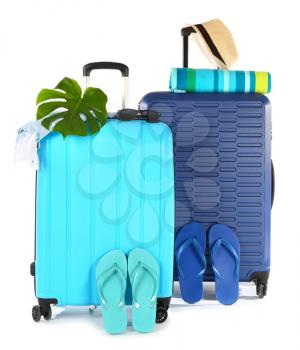 Packed suitcases with beach accessories on white background. Travel concept�
