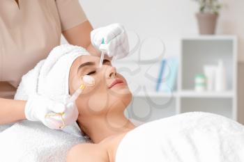 Young woman undergoing treatment in beauty salon�