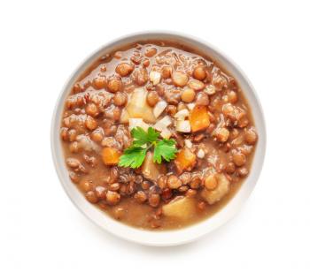 Bowl of tasty lentils soup on white background�