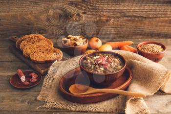 Bowl of tasty lentils soup on table�