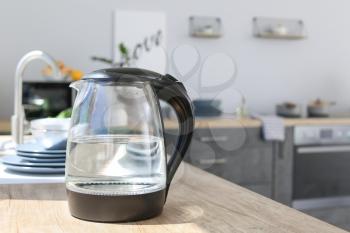 Modern electric kettle on kitchen counter�