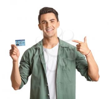 Young man with driving license on white background�