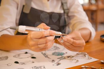 Female jewelry designer working in office, closeup�