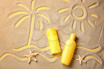 Composition with sunscreen cream on sand�