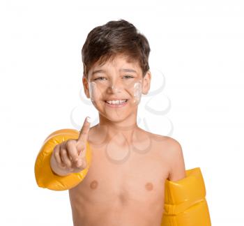 Little boy with sun protection cream on his face against white background�