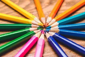 Set of colorful pencils on wooden background�