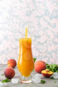 Glass of fresh peach juice on table�