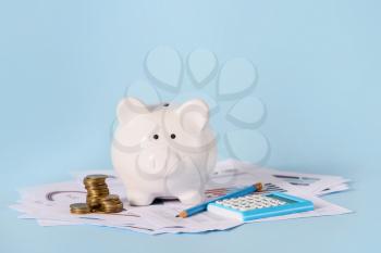 Piggy bank with savings, calculator and documents on color background. Concept of pension�