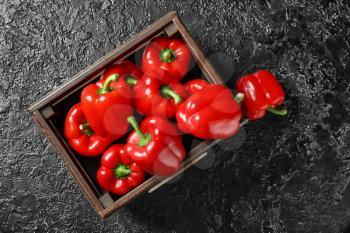 Box with red bell pepper on dark background�