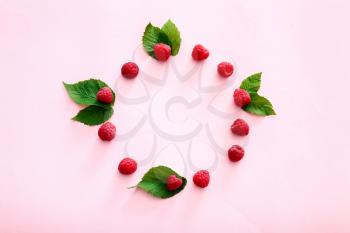 Frame made of ripe raspberries on color background�