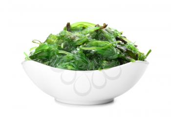 Bowl with tasty seaweed salad on white background�