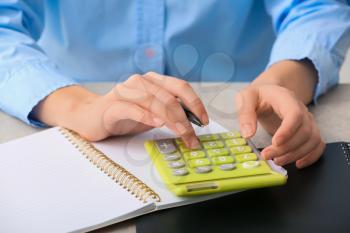 Female accountant with calculator working in office, closeup�