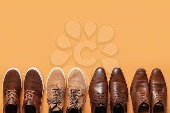 Different male shoes on color background�