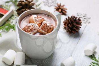 Cup of hot cacao drink with marshmallows on table�