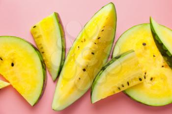 Cut yellow watermelon on color background�