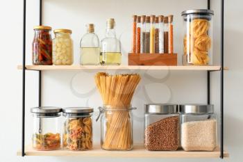 Jars with products on kitchen shelves�
