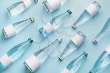 Bottles of clean water on color background�