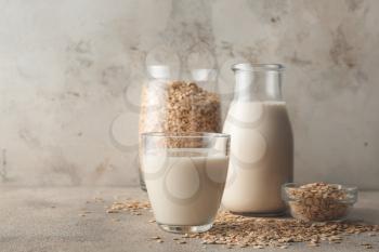 Jug and glass of oat milk on table�