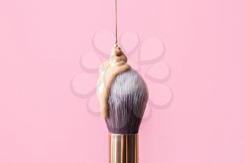 Brush with foundation for makeup on color background�