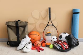 Set of sport equipment on floor near color wall�