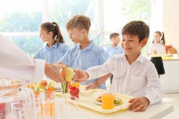 Pupils receiving lunch in school canteen�
