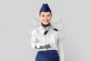 Beautiful stewardess on grey background�