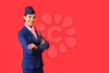 Beautiful stewardess on color background�