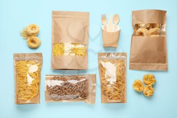 Bags with different pasta on color background�