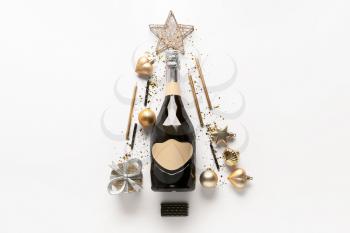 Beautiful New Year composition with champagne on light background�