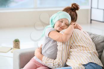 Little girl after chemotherapy with her mother at home�
