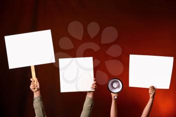 Protesting people with megaphone and placards on dark background�